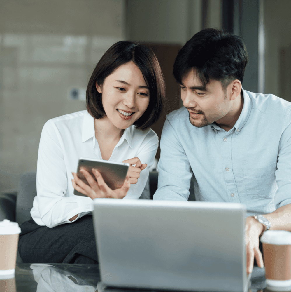 Couple calculating car loan payoff on a laptop