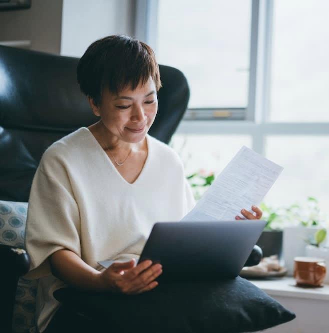 A woman reading car loan papers