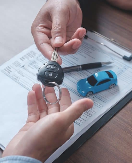 Handling a car key to buyer